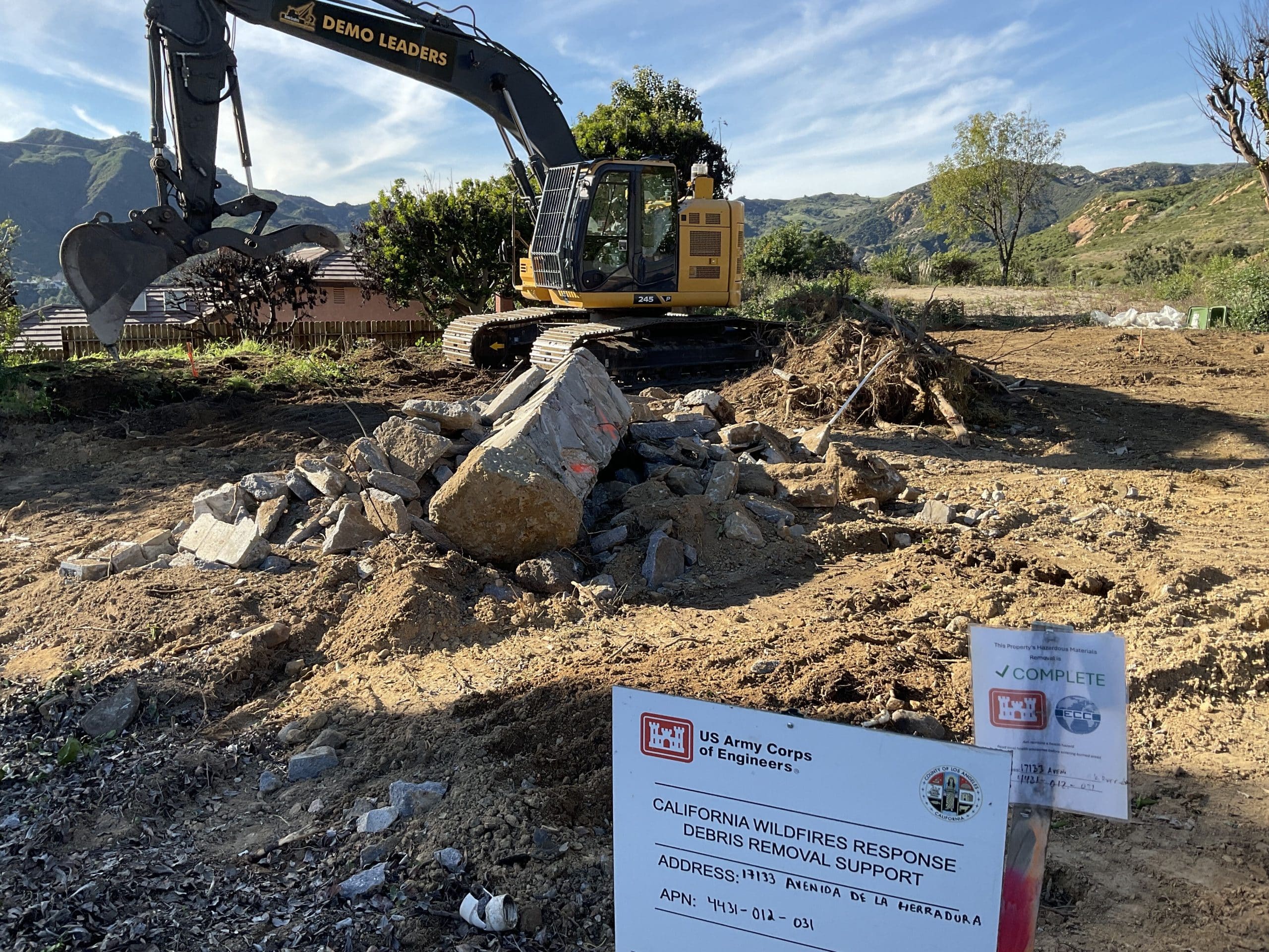 Cleared lot on Avenida Herradura after Palisades Fire debris removal, Santa Monica Mountains behind