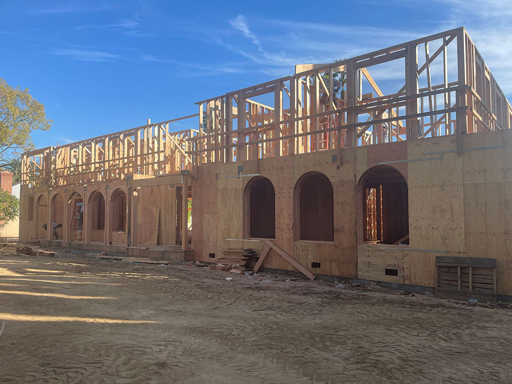 Two-story framing with signature Spanish arched openings on the San Marino custom home