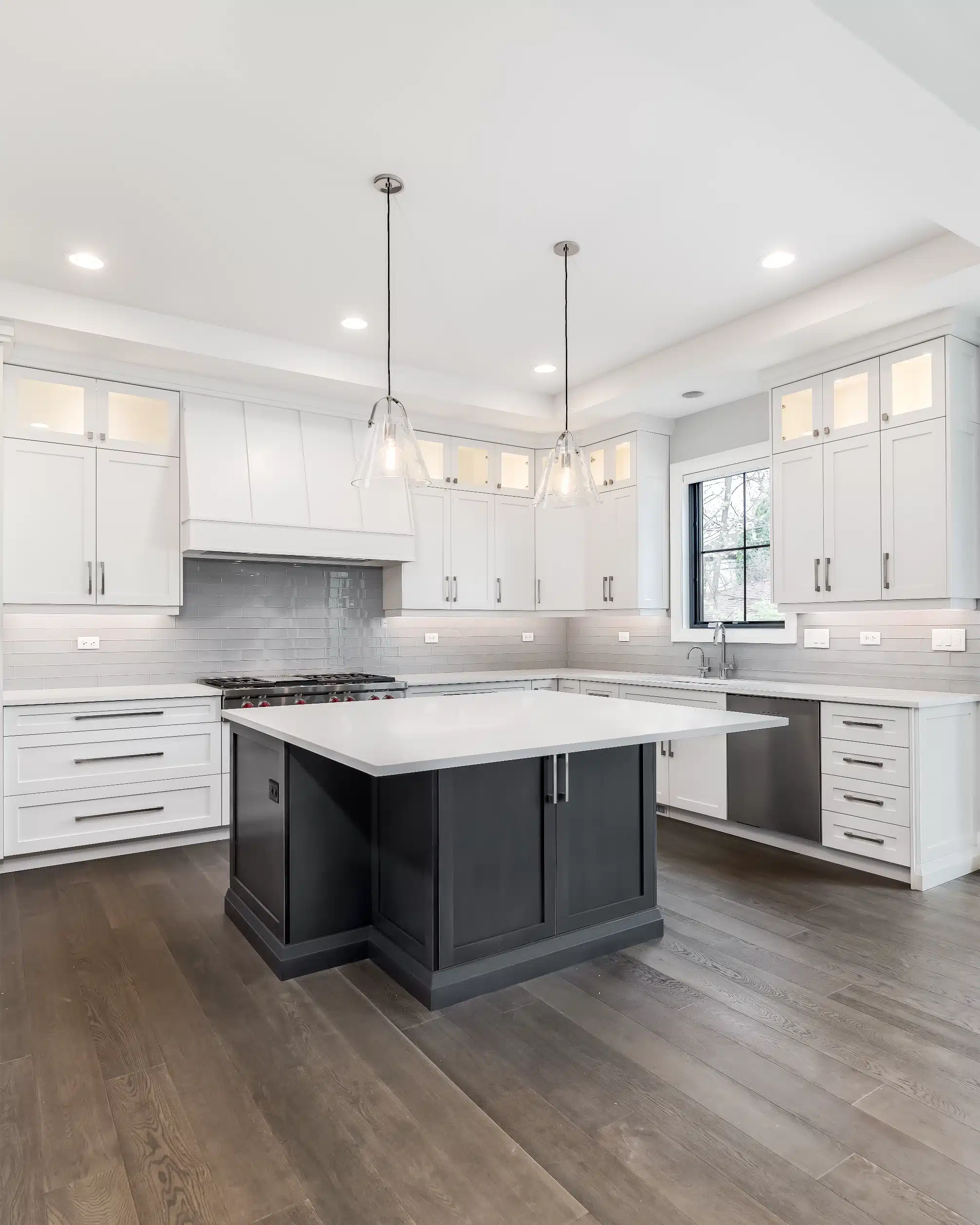 Refreshed kitchen with island, custom cabinetry, and pendant lighting