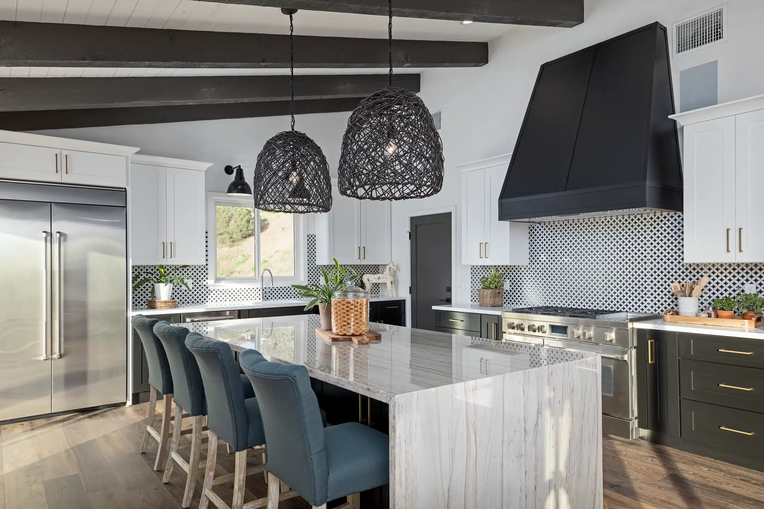 Remodeled kitchen with large island, exposed beams, and custom hood