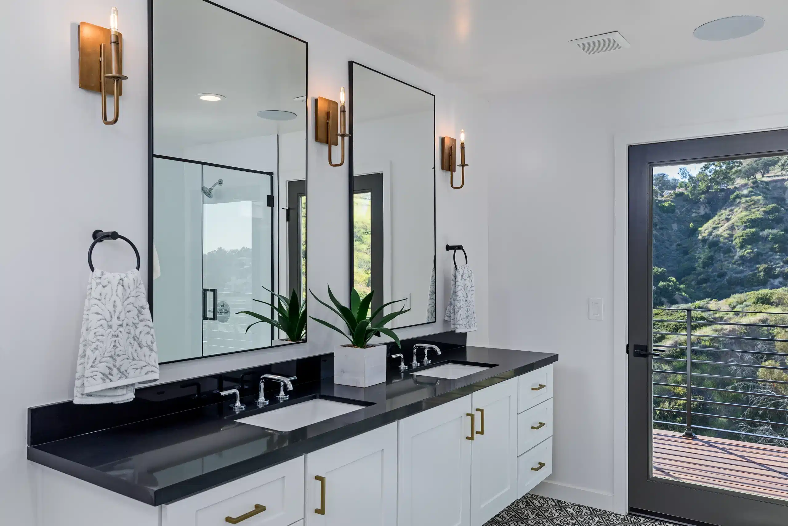 Remodeled primary bathroom with double vanity and custom finishes