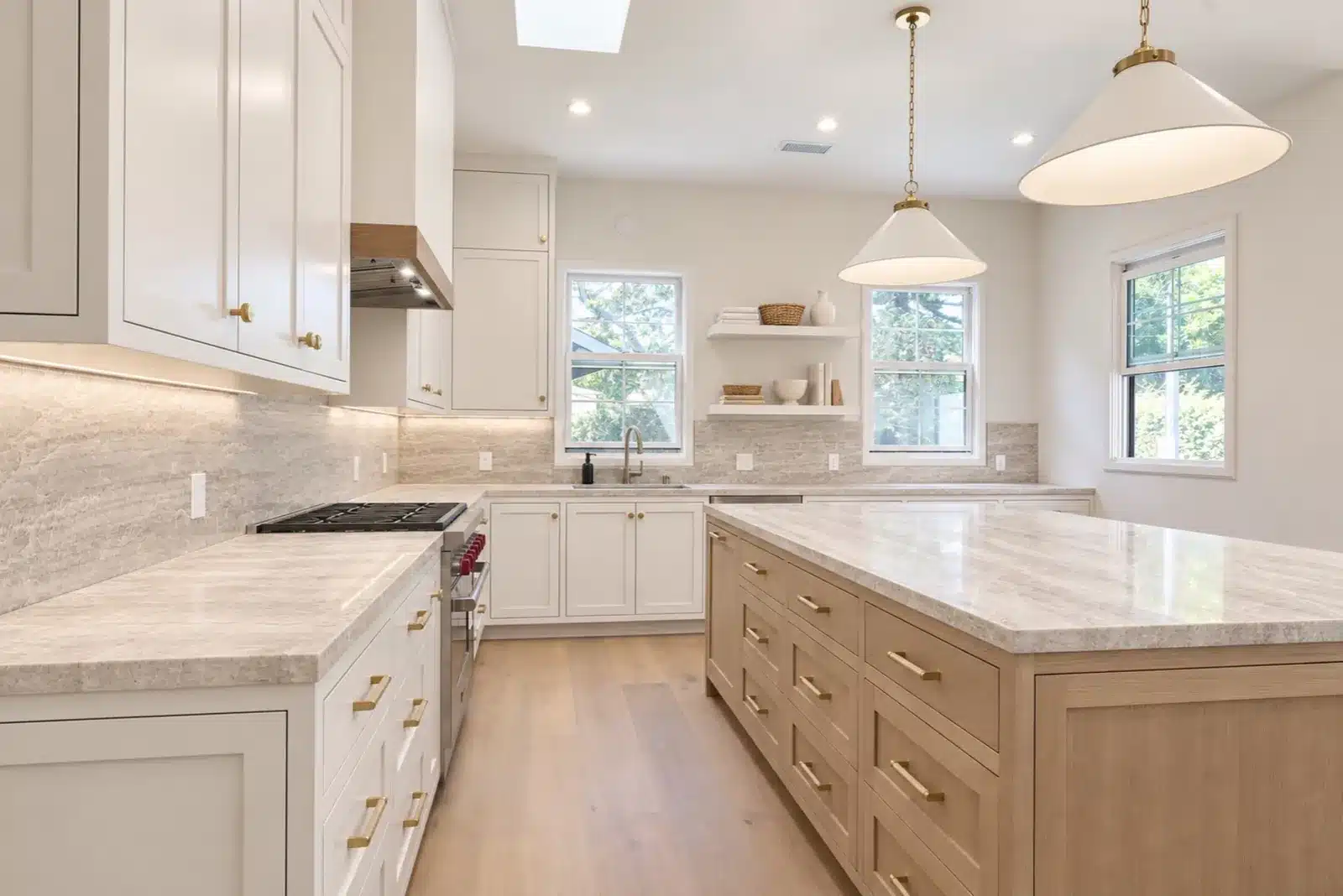 View down the kitchen past the oak island to the sink windows